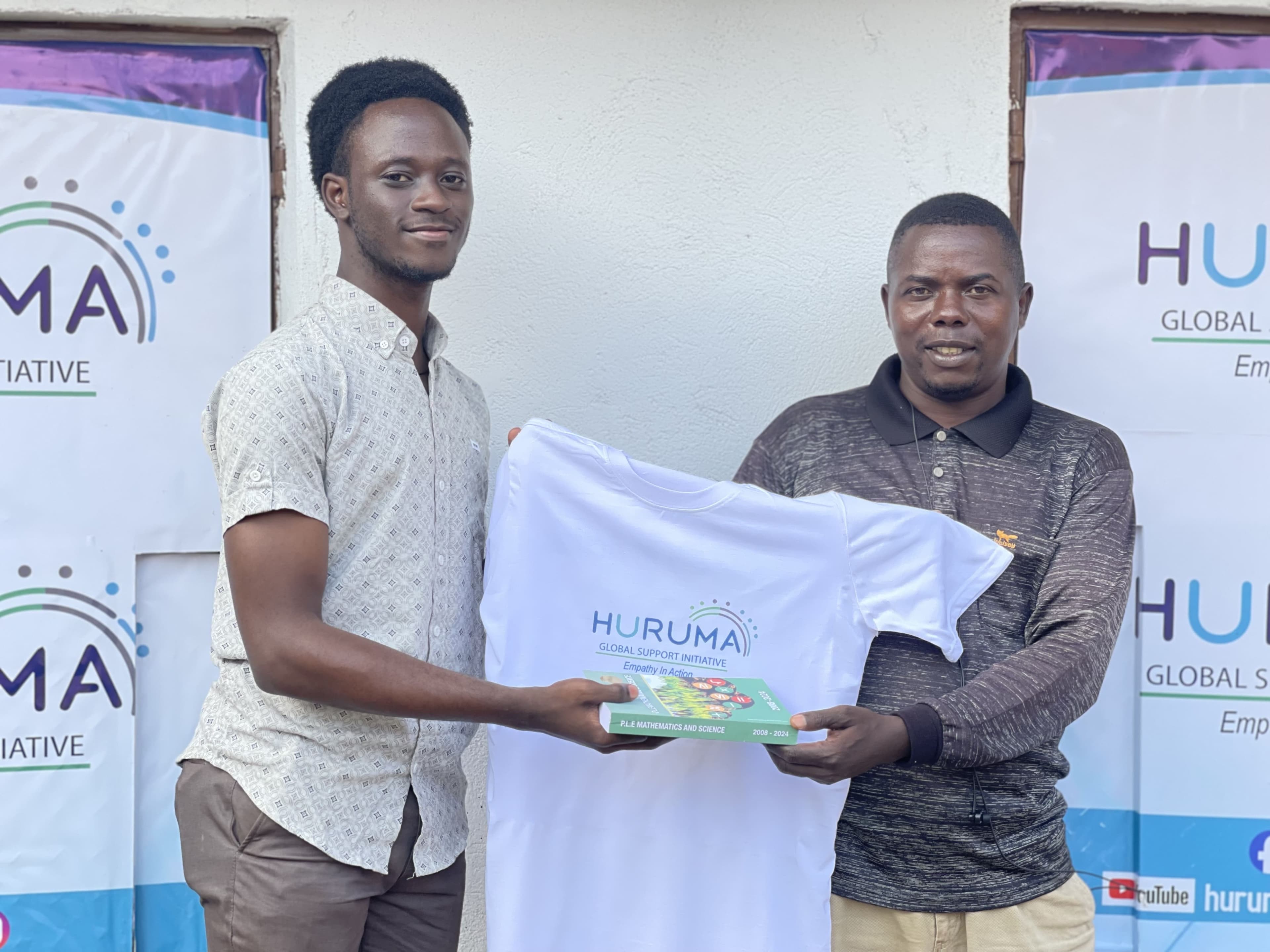 A Huruma team member handing over learning materials at a partner school